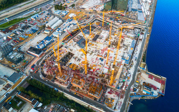 istock Aerial view of a Construction crane tower. Top view Crane and building working progress. Worker. Construction Site view by drone. Aerial top view a New buildings with a crane. Tower crane 1039433732