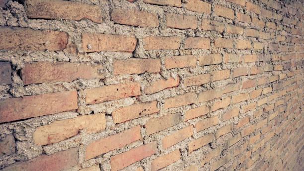 istock Side view of old orange vintage brick wall 1039438446