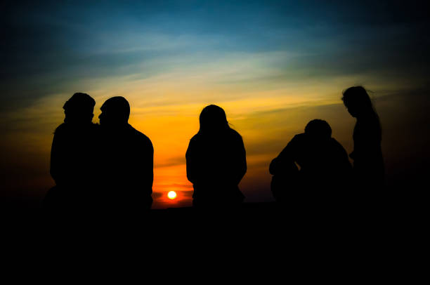 istock Silhouette Friends Against Sky During Sunset 1039444170