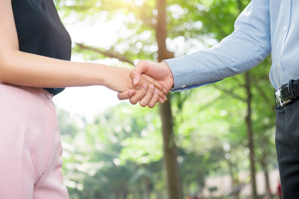 istock Two business people shaking hands after approving the agreement 1039454508