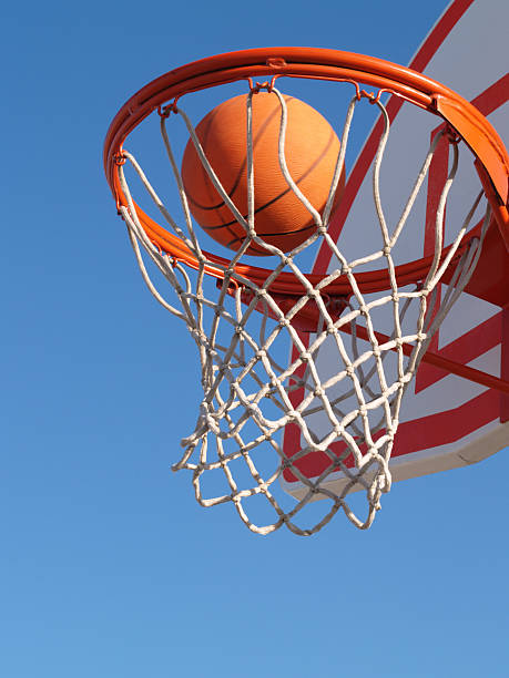 istock Basketball in a hoop on blue background 103946321
