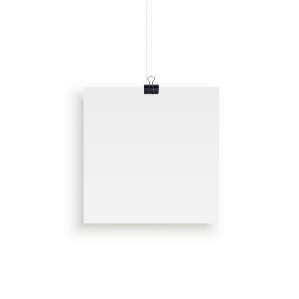 istock White square paper sheet hanging on paper clips isolated on white background. Vector design element. 1039466956