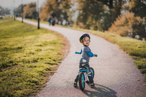 istock Cute smiling kid enjoying on a bicycle outdoors. 1039468094