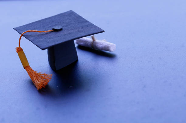 istock Black graduation cap, diploma in classroom. graduate certificate program, Education Insight Concept 1039472416