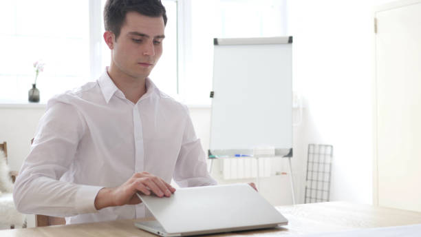 istock Businessman Leaving Office after Closing Laptop at Work 1039472754