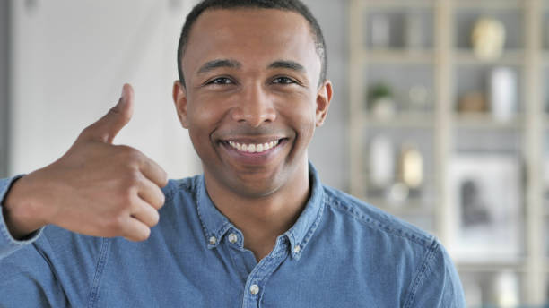 istock Thumbs Up by Young African Man Looking at Camera 1039474008