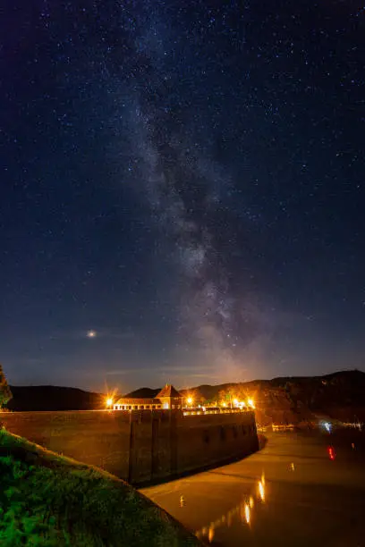 The Milky Way above the lake Edersee and reservoir dam