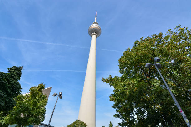 istock The Berlin Fernsehturm with trees and blue sky from below 1039481222