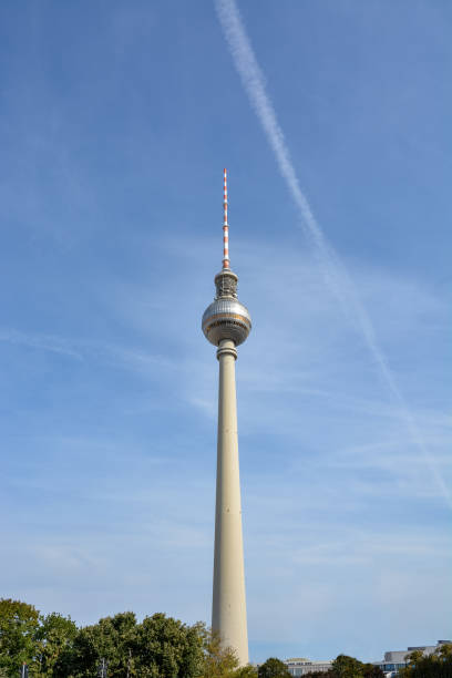 istock The Berlin Fernsehturm with trees and blue sky from below 1039481370
