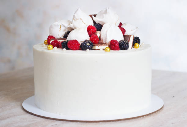 White festive cake with meringue and berries.