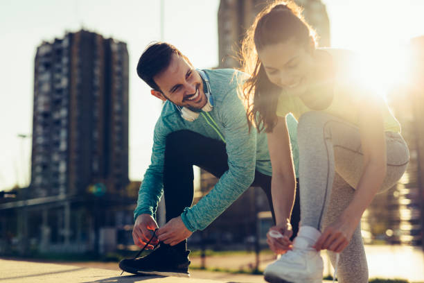 istock Runners tying running shoes and getting ready to run 1039489654