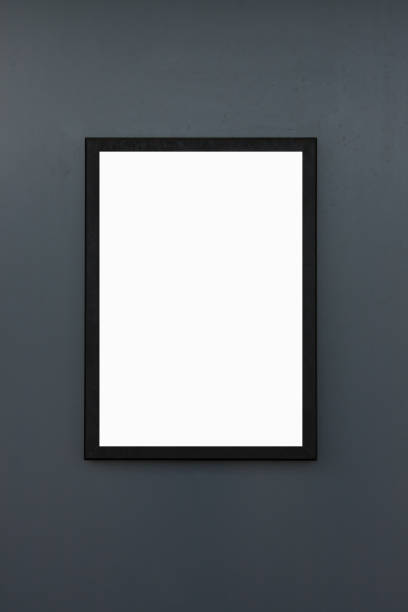 istock blank black frame on dark grey wall background and texture, white mock up for poster on grunge concrete panel. 1039491098