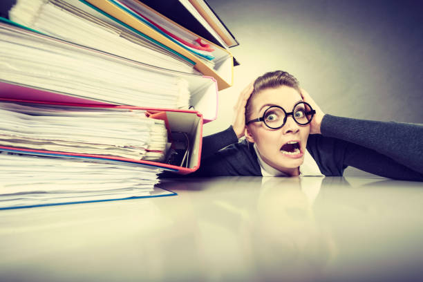 istock Accountant terrified of pils of binders. 1039501114