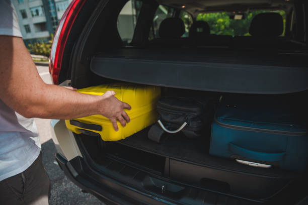 istock hands load bags in car trunk 1039505314