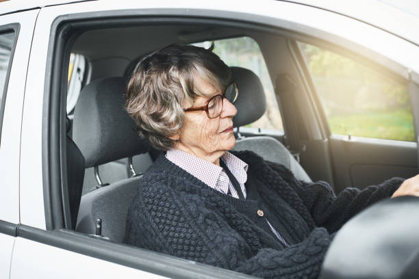 istock Confident senior woman driving her car 1039516434