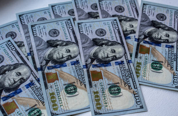 istock a one hundred dollars bills on white background 1039516918