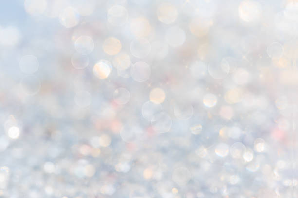 istock silver and white bokeh lights defocused. abstract background 1039518282