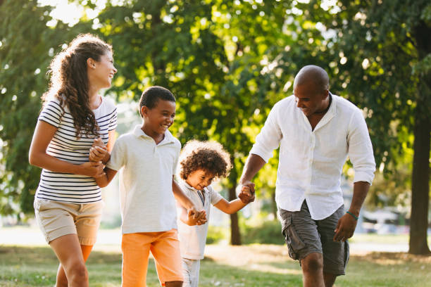 istock Happy couple spending time with their sons in the park 1039523192