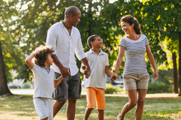 istock Happy couple spending time with their sons in the park 1039525842