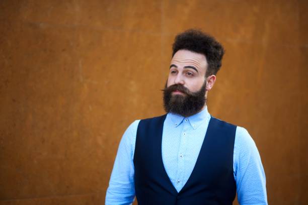Portrait of elegant bearded hipster person somewhere in the city.