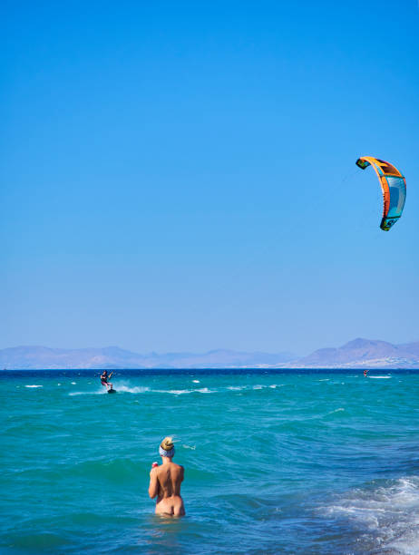 Kos, Greece - July 4, 2018. A young man practicing Kitesurf in a beach of the Greek island of Kos. South Aegean region, Greece.