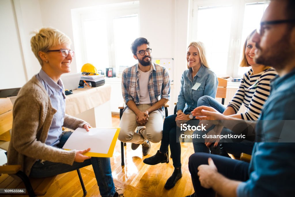 グループ療法の円で座っている人のグループです。セラピストが自分を見て、ti の彼女の話を聞きます。 - 研修のロイヤリティフリーストックフォト