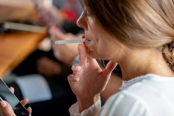 istock Businesswoman looking at phone, smoking cigarette 1039533730