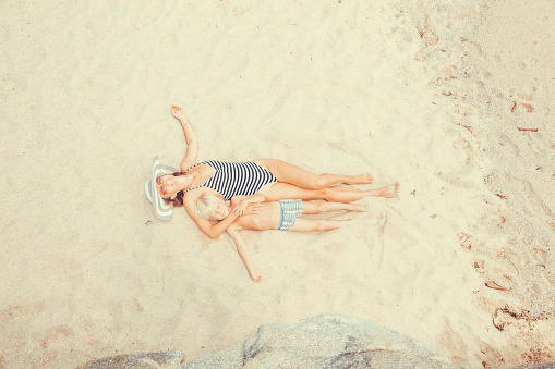 woman and ki sunbathing on the tropical beach
