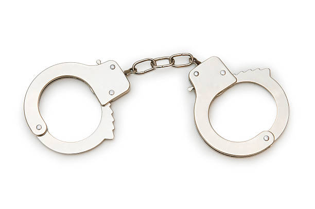 istock Metal handcuffs isolated on the white background 103954368
