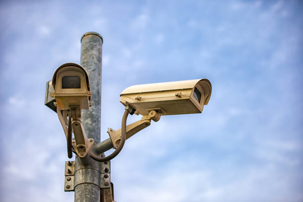 istock Close-Up Of Security Camera On Pole Against Sky 1039552142