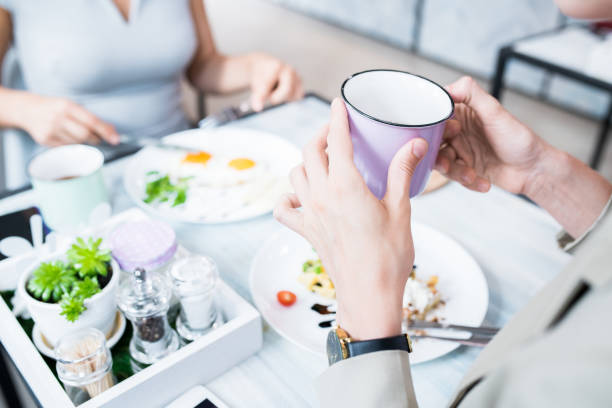 Woman Holding Cup in Cafe
