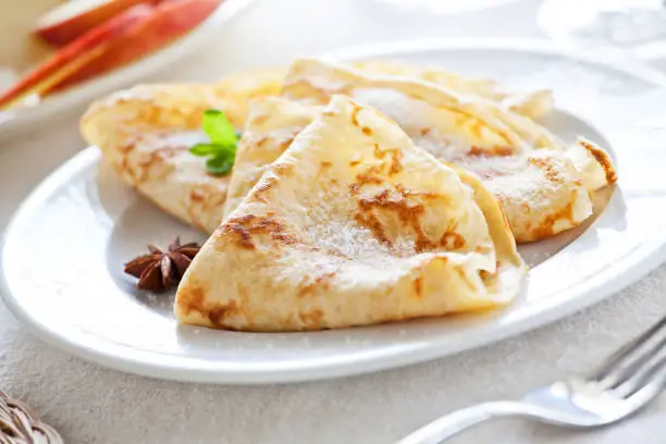 Bunch of homemade french crepes with sugar