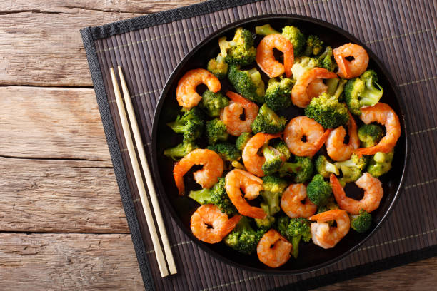 istock Stir frying shrimp with broccoli closeup. Horizontal top view 1039560056