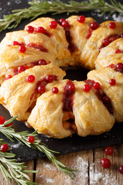 istock Festive meal: pie with meat, cranberry, rosemary and cheese close-up. vertical 1039561264