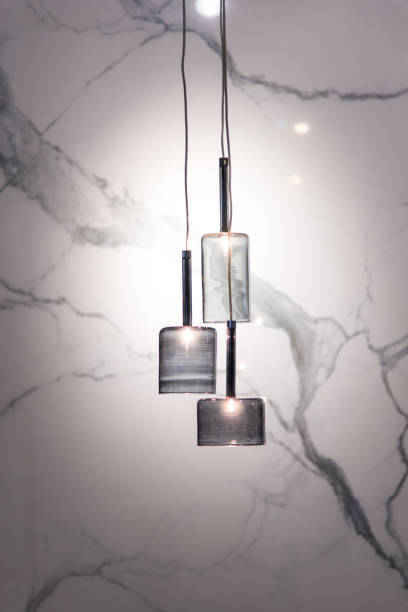 istock Illuminated Pendant Lights Hanging Against Wall 1039565408