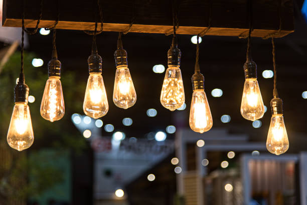 istock Close-Up Of Illuminated Light Bulbs Hanging From Ceiling 1039565420