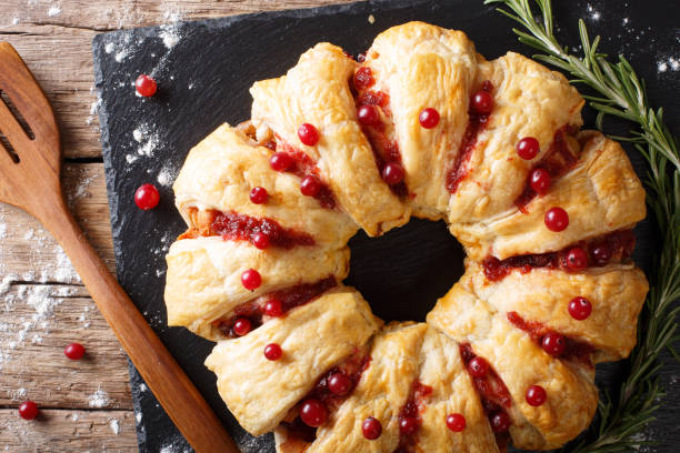 istock Christmas food: pie with meat, cranberries, rosemary and cheese close-up. horizontal top view 1039566966
