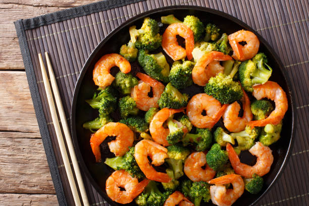 istock healthy food: stir fry shrimp with broccoli closeup. Horizontal top view 1039568670