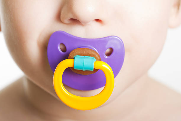 Child with baby pacifier stock photo