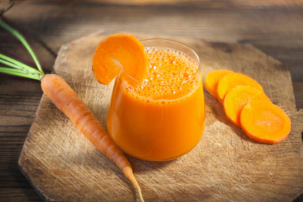 istock Carrot juice in glass on  table 1039571558