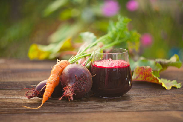 beet-Carrot juice in glass on  table stock photo