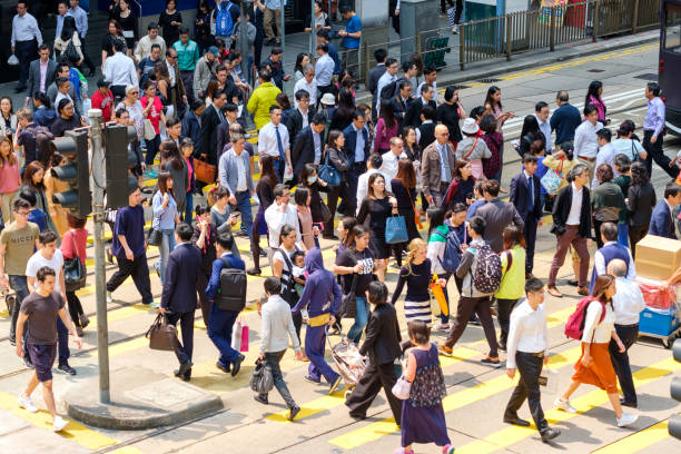 Busy pedestrian crossing at Hong Kong Busy pedestrian crossing at Hong Kong people walking stock pictures, royalty-free photos & images