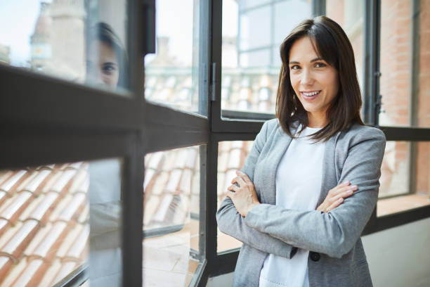 istock Business portrait. Looking at camera in an open space office. 1039578242