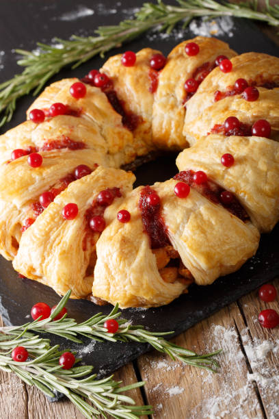 istock Christmas chicken pie with cranberries and cheese close-up. vertical 1039579708