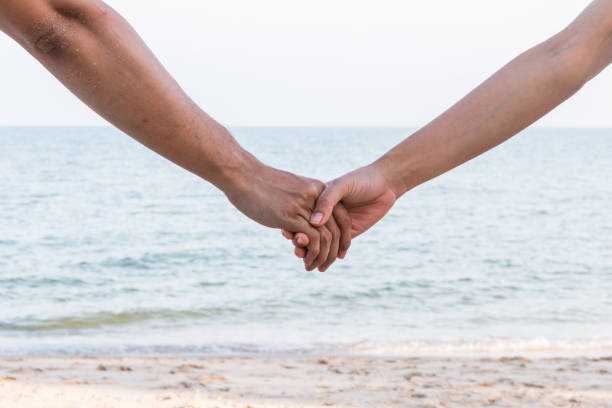 istock lover hold hand on the beach, vintage style 1039579868