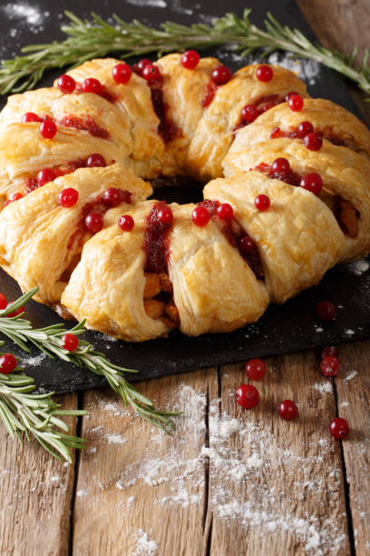 istock Christmas food: pie with meat, cranberries, rosemary and cheese close-up. vertical 1039579990