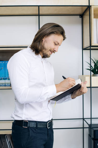 istock Young businessman taking notes on his agenda 1039584212