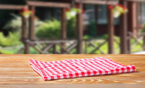 istock Tablecloth in a cage on a wooden table, behind the backdrop 1039586242