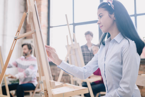 istock Young Woman Painting in art Studio 1039587162