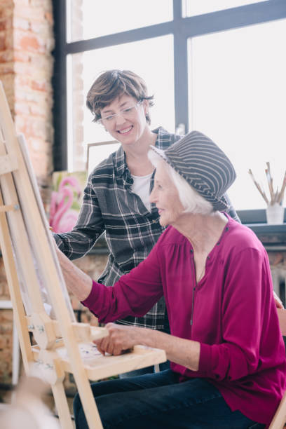 istock Happy Senior Woman in Art Class 1039587174